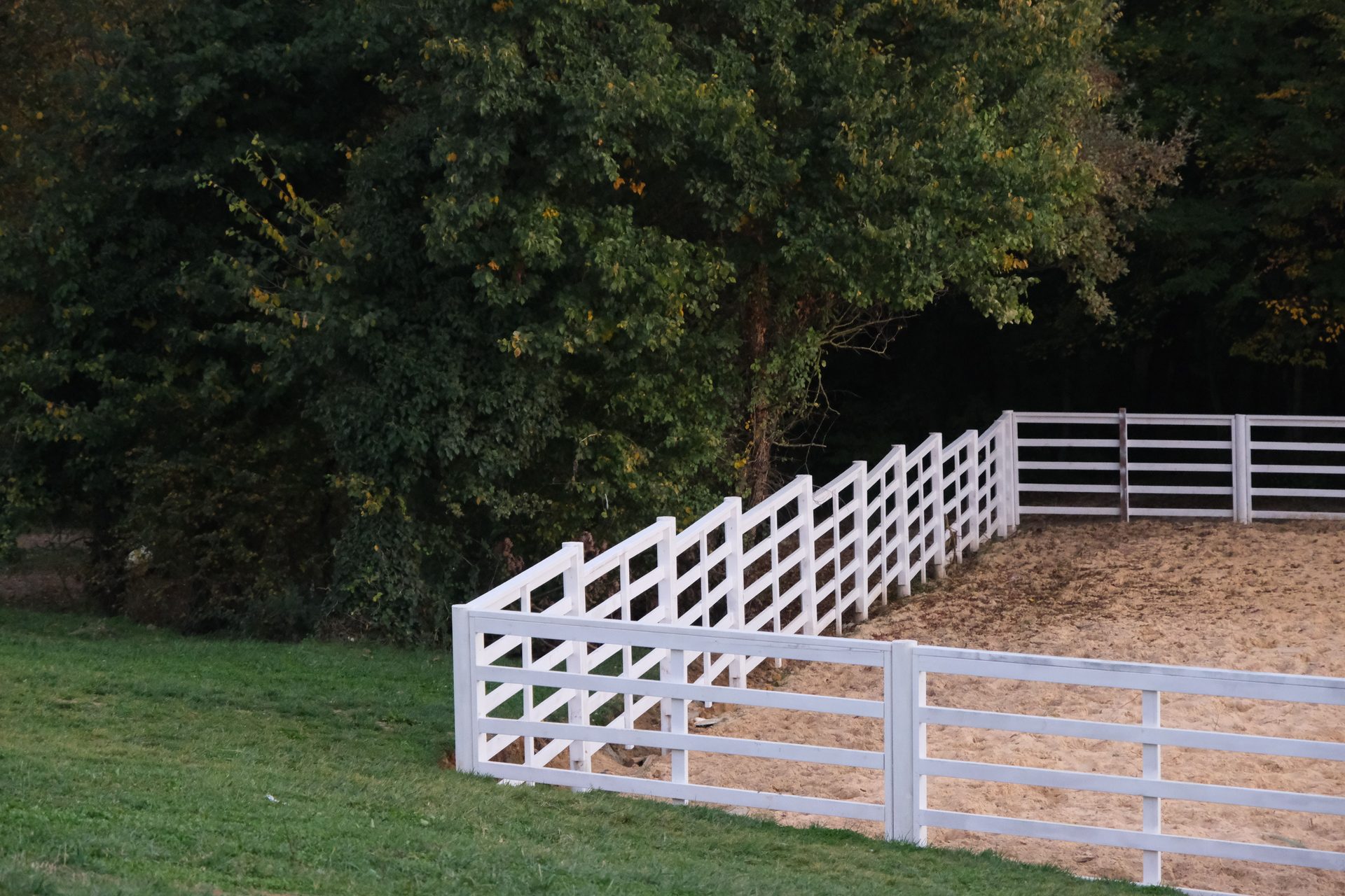 Custom white estate-style privacy fence installed along a manicured lawn in Hampton Roads, VA